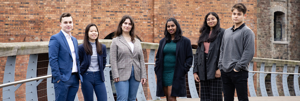 group of male and female students stood on a bridge in Bristol